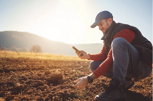 Man looking at soil