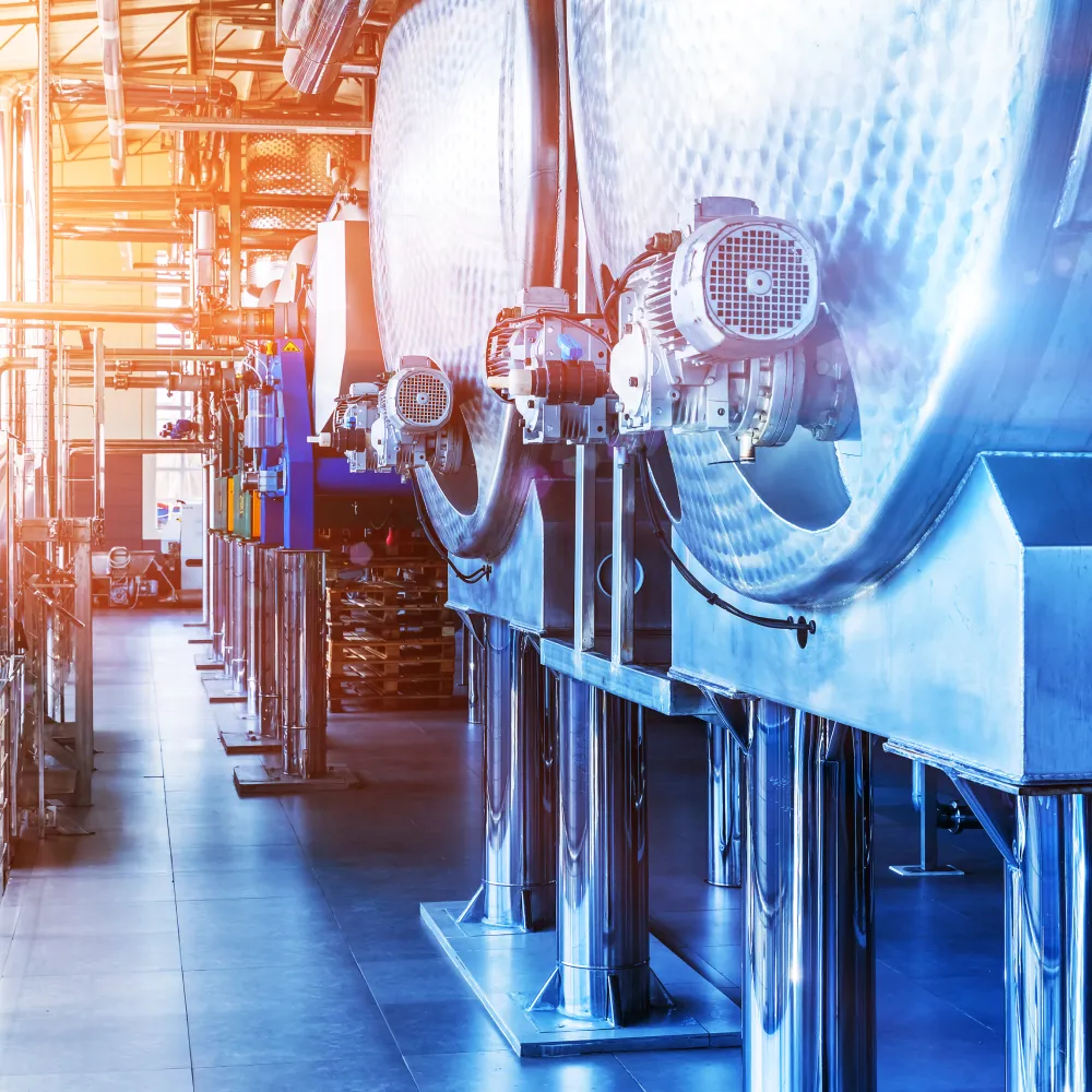 Industrial chemical processing equipment in a well-lit factory setting