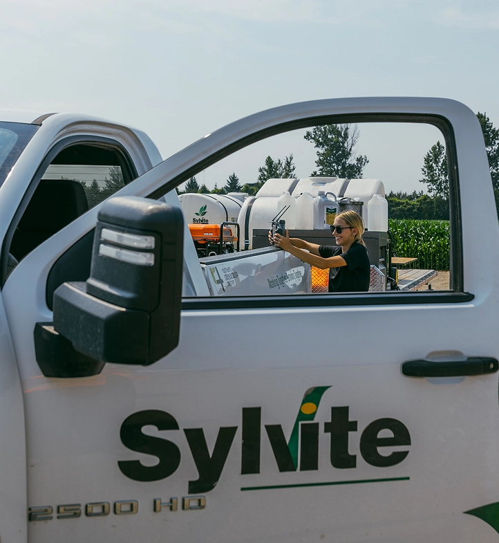 Sylvite team member taking a photo from a Sylvite truck at a field site