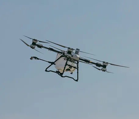 Agricultural spray drone flying in a clear sky
