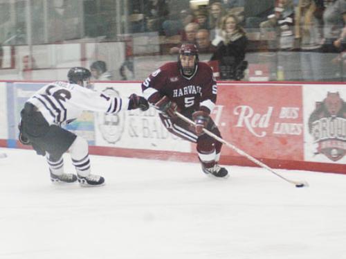 Junior defenseman Noah Welch skates past Brown's Les Haggett. Welch scored the Crimson's first goal of the series in Friday night's 4-2 win over Brown, breaking a 0-0 tie less than a minute into the second period to give Harvard the lead.