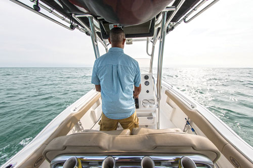 man-standing-in-power-boat man-standing-in-power-boat