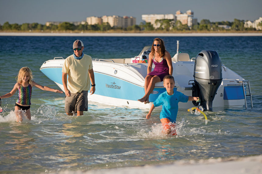 family-walking-to-shore-from-boatx860