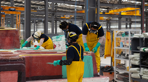 GARY REICH PHOTO  Fiberglass workers in Warbird’s Mérida, Mexico, facility lay up a deck mold.