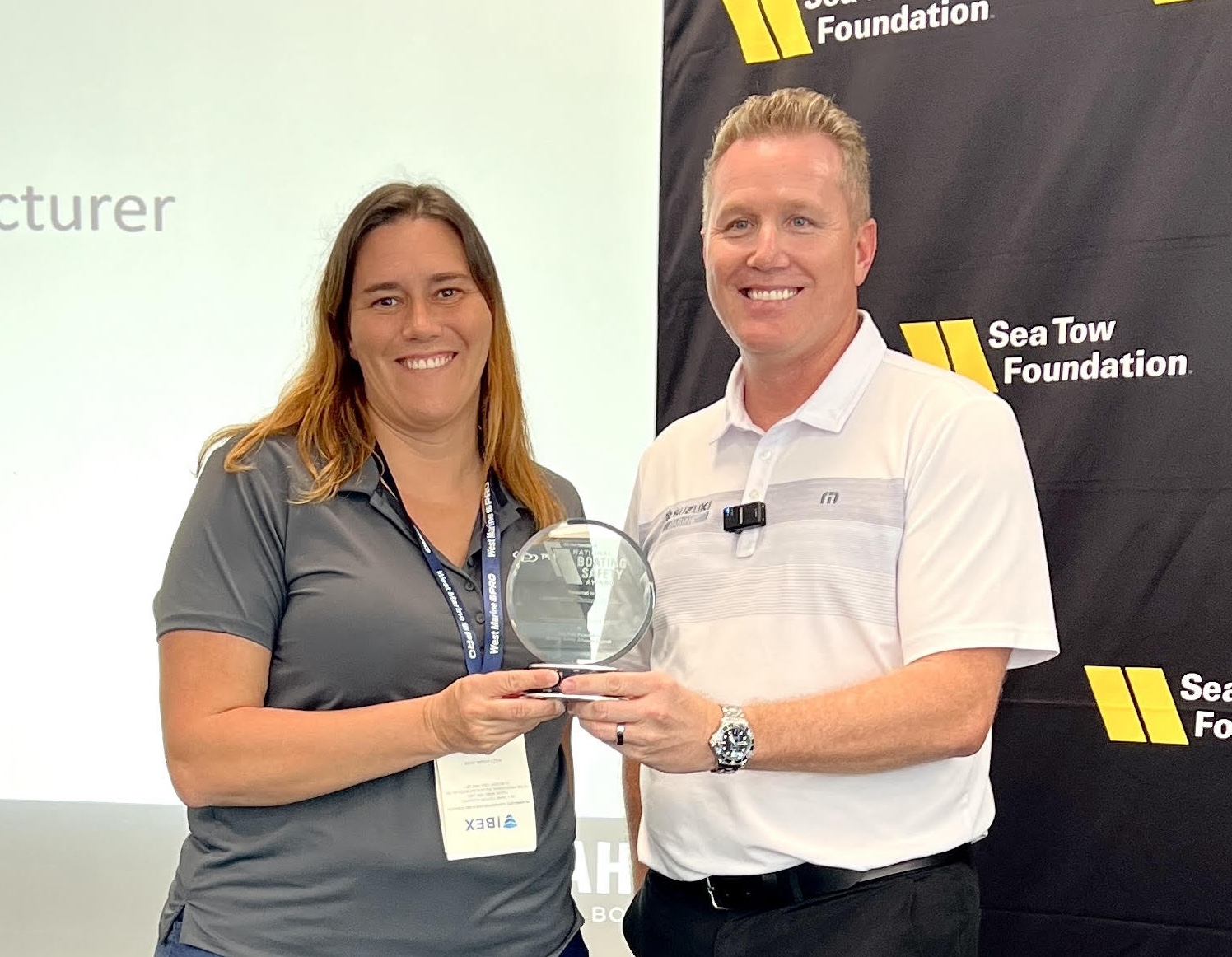 Pursuit vice president of engineering Molly Ditzler receives the award from Suzuki vice president of sales and marketing Brandon Cerka. PHOTO COURTESY PURSUIT