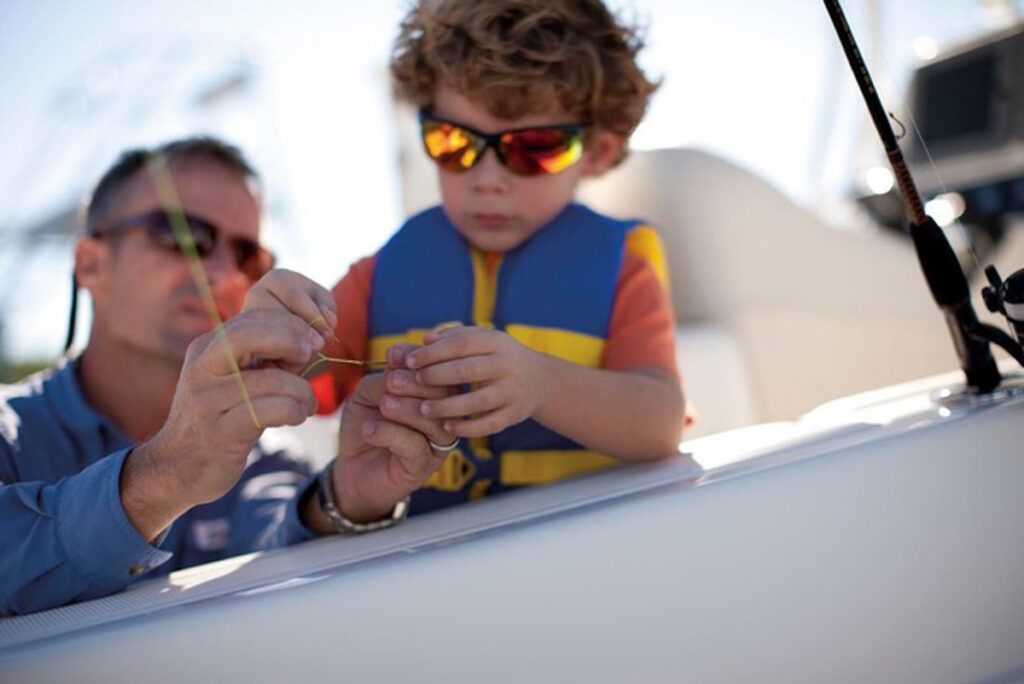 father and son baiting hook
