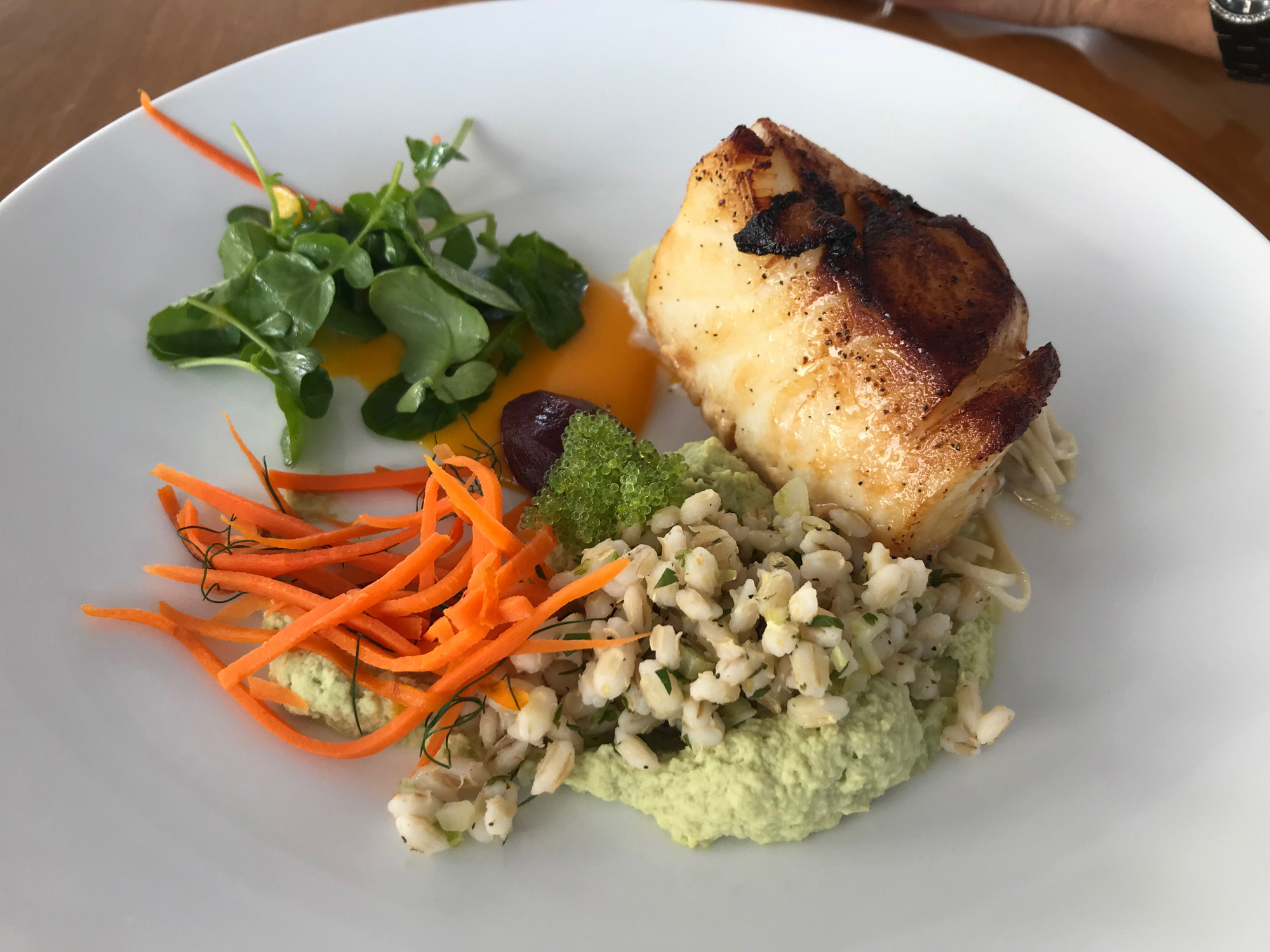 Soy-braised sea bass fillet with pearl barley, edamame-orange purée, watercress, balsamic-glazed beetroot, cucumber nage, tobico wasabi, carrots with dill, and enoki mushrooms
