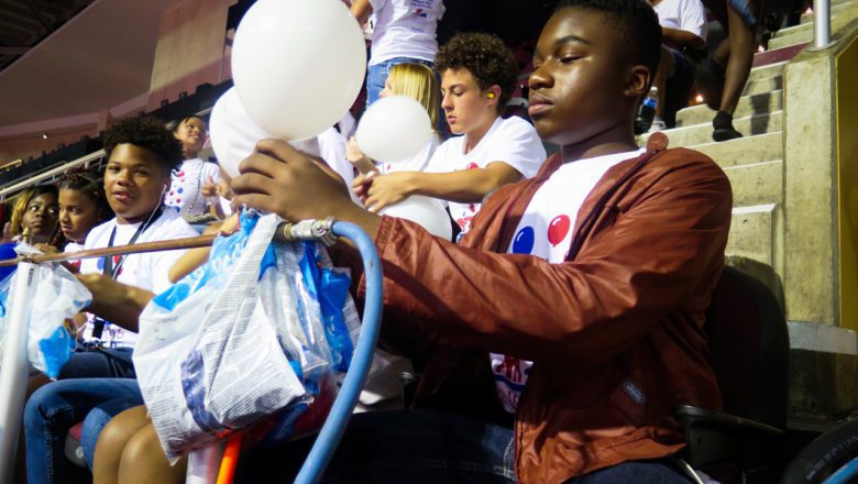 Alto saxophonist and 15-year-old Holland Petway uses a pressurized air spigot to blow up a balloon quickly. After, he’ll tie it by hand. Photo: Phoebe Petrovic/Youth Radio