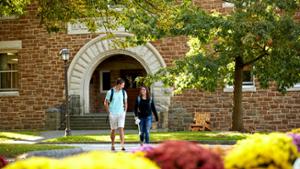 Students walk in from of Benedict Hall