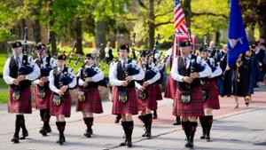 The Mohawk Valley Frasers Pipe Band lead the processional of graduates before the 2024 commencement ceremony.