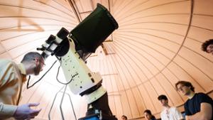 Associate Professor for Instruction of Physics Adam Lark (left) with the new Planewave telescope at Peters Observatory