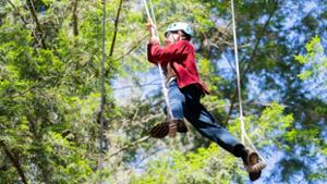 A student on the ropes course at the Oswegatchie Educational Center in the Adirondacks. August 2025. 