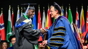 President Tepper congratulates a graduate.
