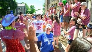 New students, returning students, family, friends faculty and staff, make their way through a gauntlet