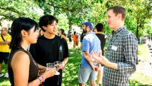 Michael Welsh, Associate Professor of Chemistry, chats with Kristen Yeung &rsquo;30 and her brother, Kaiden.