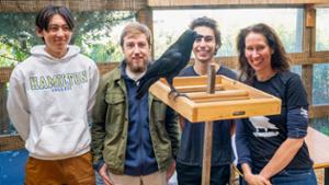 Simon Shin &rsquo;29, Spencer Stephens &rsquo;28, Demetri Passalaris &rsquo;29, and Associate Professor of Biology Andrea Townsend pose for a photo behind Lenore.