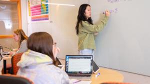 A tutor works with a student at the QSR Center.