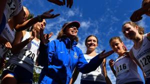 Women’s cross country and track and field coach Ellen Hull motivates her team at the Hamilton Cross Country Fall Invitational.