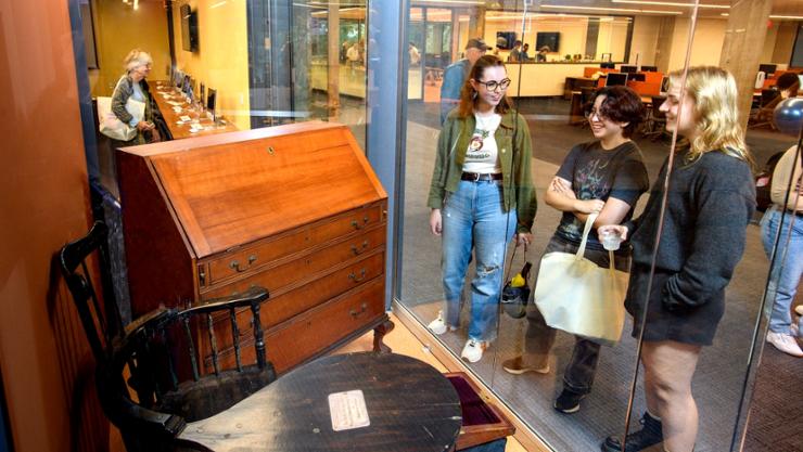 Visitors look at Rev. Samuel Kirkland’s desk during Fallcoming weekend