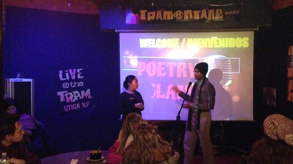 Seniors Shaina Coronel and Sacharja Cunningham introduce a Hispanic Studies poetry slam at the Tramontane Cafe in Utica, N.Y.