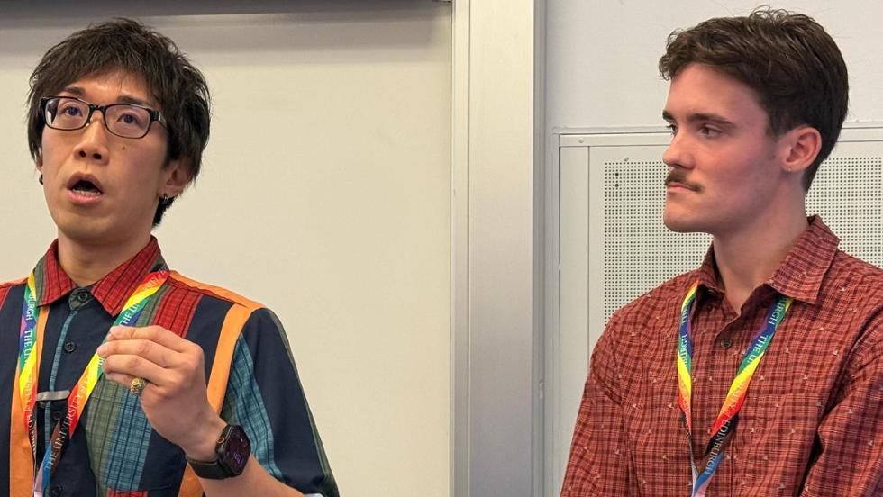 Assistant Professor of Anthropology Spencer Chen, left, and Carter Higgins '27 present at the University of Edinburg, UK.h.