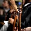 seniors hold canes at commencement