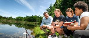 Professor Aaron Strong works with students at reservoir