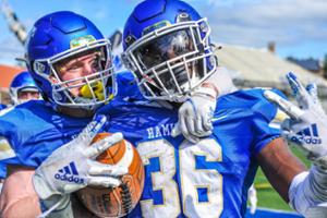 Running back Kamau Hopewell &rsquo;25 (right) celebrates with teammate after scoring a touchdown against Amherst.