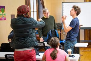 Phil Bean chats with students during his class on the history of Utica media.