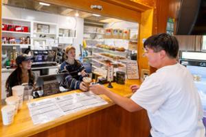 A student grabs a coffee at FoJo south on the dark side of campus