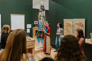 A class explores the Menagerie exhibition at the Wellin.