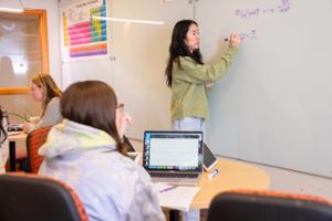 A tutor works with a student at the QSR Center.