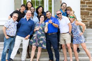 A posed photo of a group of adults on a staircase.