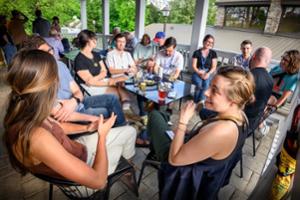 A group of people sitting around a table outdoors.