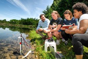 Professor Aaron Strong works with students at reservoir