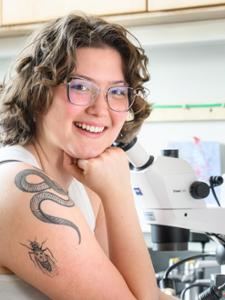 To commemorate her research, Abigail Lowder has a fruit fly tattooed on her arm, along with a snake that honors her late father, who was a herpetologist.