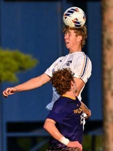 Men’s soccer defender Romaric Mahe ‘29 (34) heads the ball in a game against Williams College at Love Field on Sept. 9.