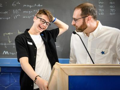 Matthew, left, reacts after Adam Lark informs him that he was just gifted a telescope.