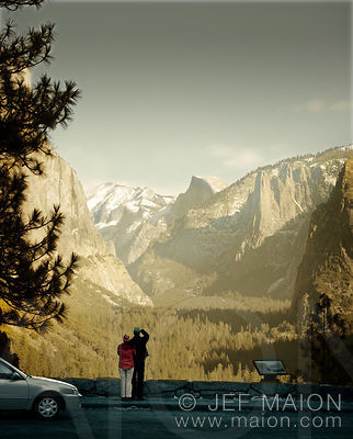 Couple and car parked at scenic overlook