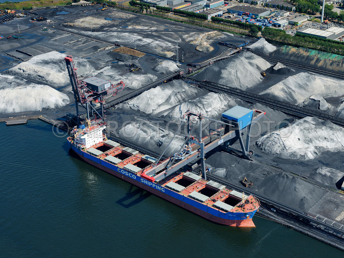 aerial view Amsterdam, a bulk carrier unloads a load of coal at the quay of the OBA bulk