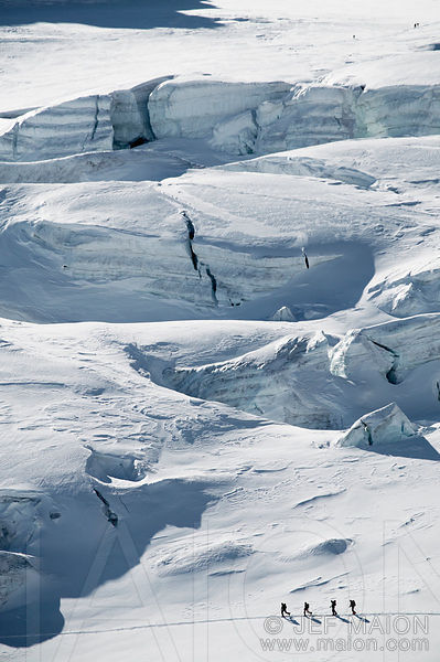 Alpine touring skiers below glacier