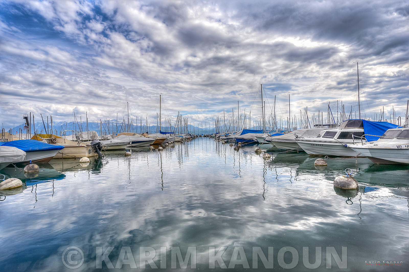 Daramatic sky reflection with boats in the middle - Vidy, Lausanne
