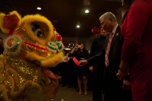 Raymond Chin feeds a red envelope to a lion