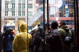 Protesters yell at the Cole Haan security guard