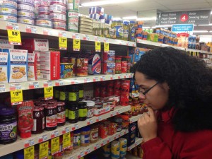 A customer examines carefully prices at a CVS Pharmacy store in Chicago on Monday, Jan. 25, 2016.