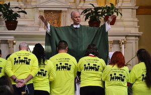 Members of the Society of Toribio Romo receive a blessing at St. Agnes of Bohemia.