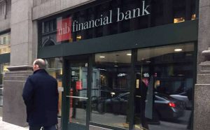 a man passing by a MB Financial bank franchise in Chicago