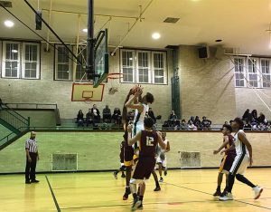 After eight years of anticipation for this moment, the boys’ basketball team’s first playoff game in nearly a decade, the Senn Bulldogs had to wait another 40 minutes. Marine Academy arrived at Senn at 5 p.m. for a 4:30 tip. Ultimately, though, it was the home team that was slow to show up. Senn trailed early in the first half and never recovered, falling 82-69 Wednesday evening in the first of three playoff games in the Blue North conference. First-year Senn coach Terrell Walsh worried in Tuesday’s practice the players wouldn’t be ready at game time, and his fears were realized when Marine (10-11) went up by 13 midway through the second quarter. “They’ve never made the playoffs, so this is what they do,” Walsh said of his players after the loss. “All season we’ve this been telling them the same thing over and over and they just don’t realize it, so is what happens.” Slow starts have plagued Senn (10-4) throughout the season. Starting point guard Noah Chapman said the team was ready to play, but the group just couldn’t recover after falling behind. “We weren’t nervous,” Chapman said. “We just came out slow, which we always do.” His coach says otherwise. “Yeah, I think they were nervous,” Walsh said. “It is what it is.” Nervous or not, Senn was rattled by the hot hand of Marine’s KeyAndre Spann. The shooting guard scored 18 of his team’s first 22 points and finished with a game-high 27. “We started off slow, and [Spann] hit a couple of shots. He killed us,” Senn assistant coach Marcus Riley said. Riley said the team shouldn’t have been nervous since they were playing at Senn, but it hardly felt like a home game at times. A small group of Marine supporters regularly drowned out any noise by the approximately 60 Senn fans that attended the game. Even though he had a full roster to work with, Walsh stuck to a six-man rotation for the duration of the game. Senn beat Marine less than a month ago with a similar strategy, but Marine Academy simply buried the Bulldogs with 13 made three-pointers. The Bulldogs have two more chances left in pool play to prove they belong in the playoffs. Despite the rough start, Walsh sees his team making it out of pool play, which takes point differential into account. “We have to a blow team out to get back in it,” he said. “I believe it’s going to work in our favor. … We still got two more games. It’s the playoffs. Anything can happen.”