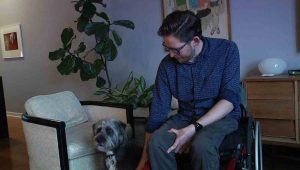 Aaron Anderson with his dog Buddy in his Uptown apartment.