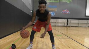 Michael Flenory dribbles the ball at his AAU team practice.